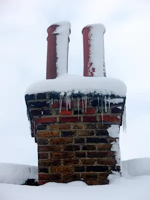 double chimney with snow ontop of it