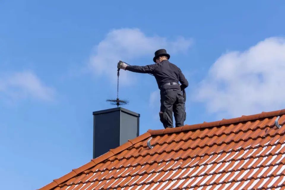 longshot view of a chimney cleaner near me working