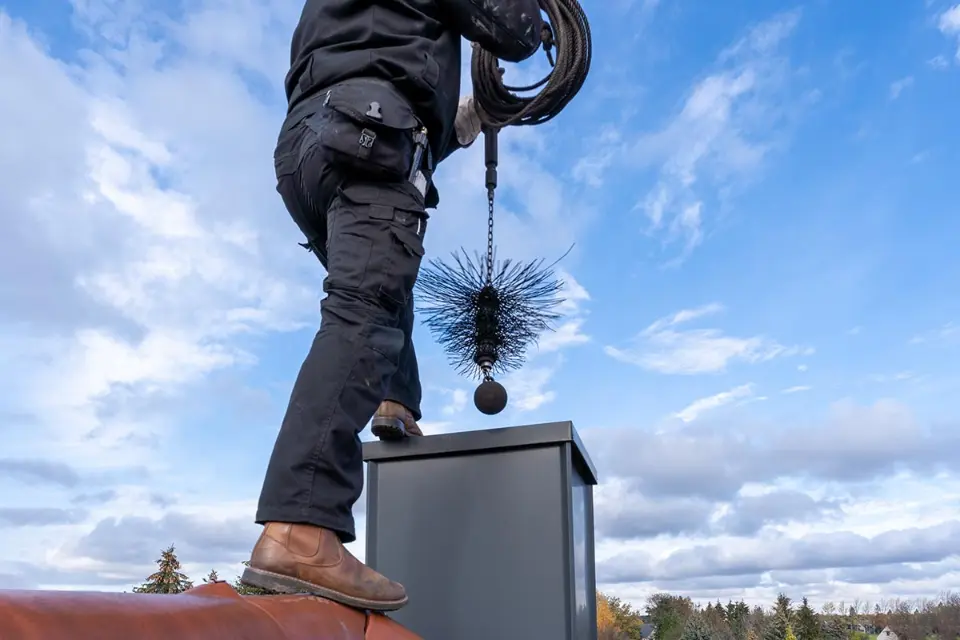 man doing chimney servicing right before winter to prepare